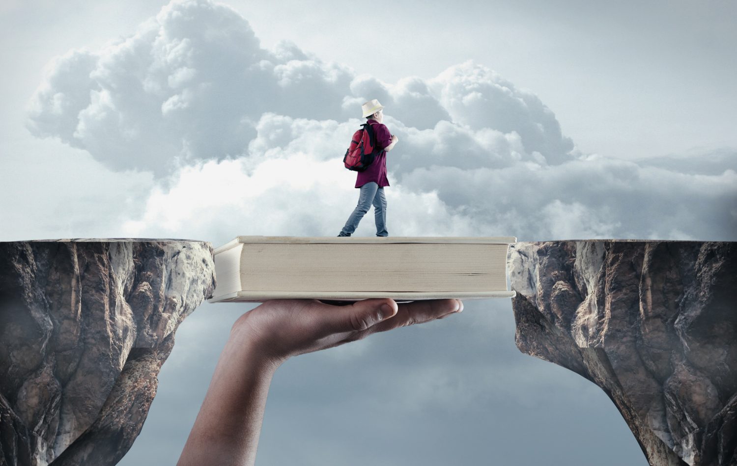 Young man passes from a peak to another on a book. The concept of scholarship.